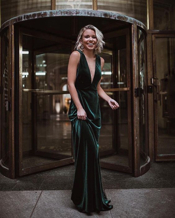 a non-traditional and very refined and elegant green velvet wedding dress with a plunging neckline, thick straps, an open back and a train