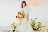 a pale green one shoulder wedding dress with layers of tulle on top is a delicate and chic idea for a spring or summer bride