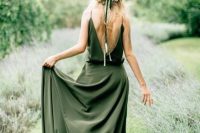 a simple and dreamy green A-line wedding dress with an open back, a skirt with a train, on spaghetti straps is amazing for a summer boho bride