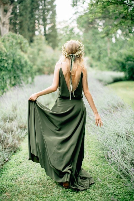 a simple and dreamy green A line wedding dress with an open back, a skirt with a train, on spaghetti straps is amazing for a summer boho bride
