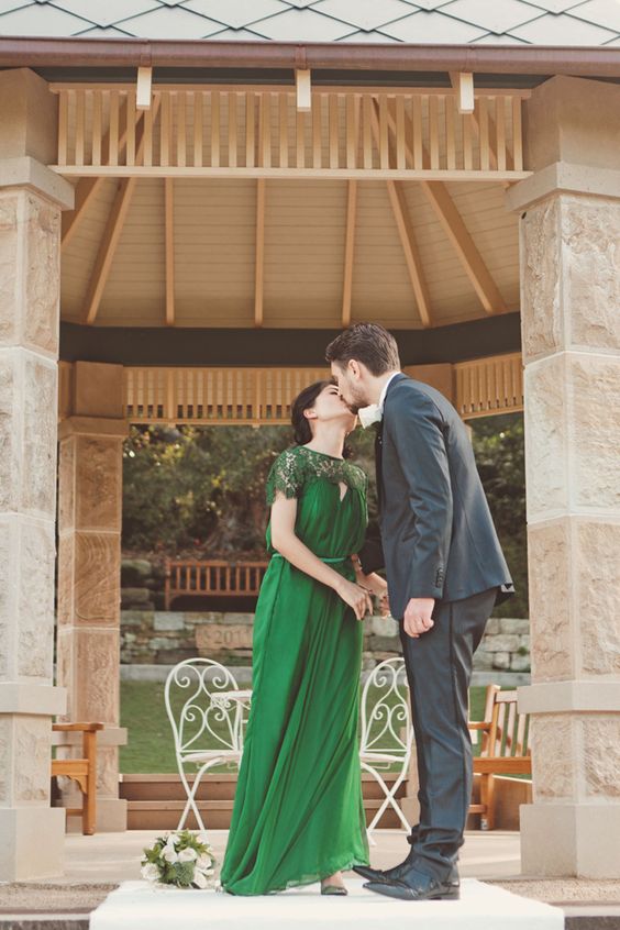 an elegant and refined art deco green wedding dress with a lace neckline, a sash and a pleated skirt is ultimate elegance to rock
