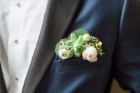 an elegant navy tux with black lapels and a pocket square for a fresh and modern touch, with blush and white blooms and succulents is wow