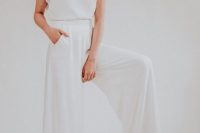 02 a 70s inspired bridal look with a white plain top with cap sleeves and wideleg pants with a train that remind of a skirt
