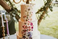 02 a white buttercream wedding cake with an ombre pressed flower pattern from purple to white is a lovely idea for a boho wedding