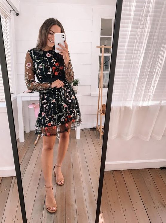 a black mini A-line dress with bright floral embroidery, nude heels and illusion long sleeves for a fall or winter wedding