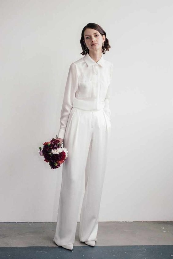 a casual bridal look with white pleated trousers, a white shirt, white heels and catchy earrings is pure style