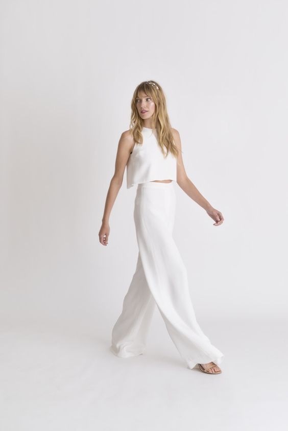 a minimalist bridal separate with a halter neckline crop top and high waisted palazzo pants plus nude shoes
