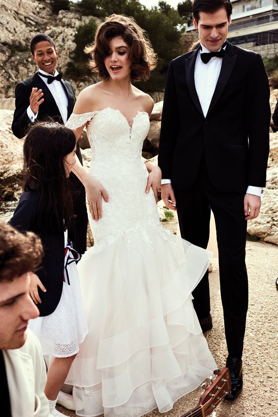 a jaw dropping off the shoulder trumpet wedding dress with a lace bodice and a ruffle skirt is very sophisticated