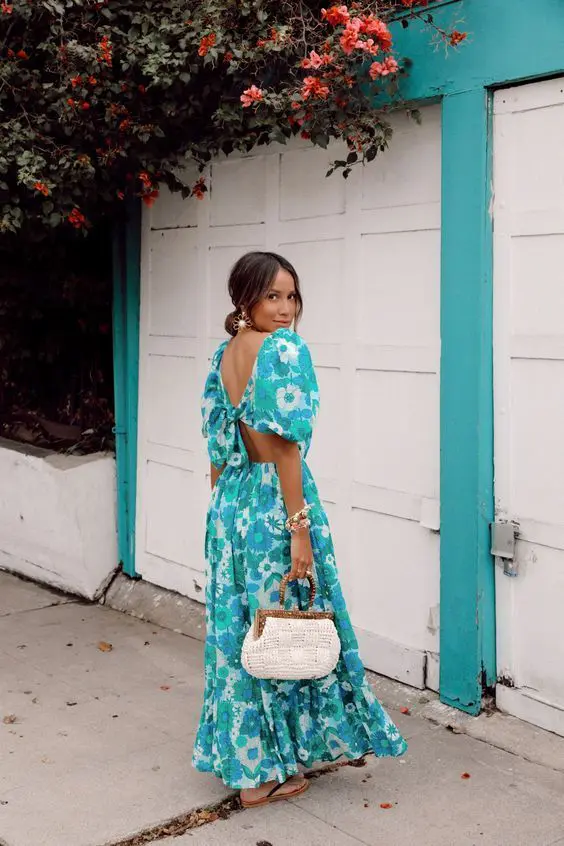 a fantastic turquoise floral print maxi dress with a cutout back, a white woven bag and statement earrings
