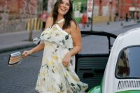 11 a floral print ruffle midi dress with a loop for your neck, silver shoes and a striped clutch