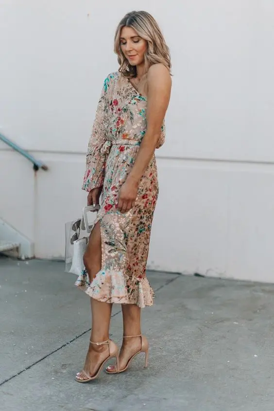 a gorgeous bright floral print one shoulder midi dress with a long sleeve and nude shoes for a lovely summer or fall garden wedding
