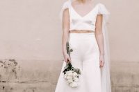 14 an ultra-modern bridal look with a plain crop top with a deep V-neckline and a tulle capelet, high waisted wideleg pants and nude shoes