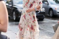 18 a light and airy floral midi dress with a plunging neckline, short sleeves, an asymmetical skirt, grey shoes with large beads