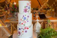 18 a white buttercream wedding cake with a pattern of pink, white and lilac pressed blooms is a lovely idea