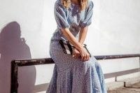 19 a light blue printed midi dress with an asymmetrical skirt, short sleeves, a high neckline, black shoes and a striped clutch