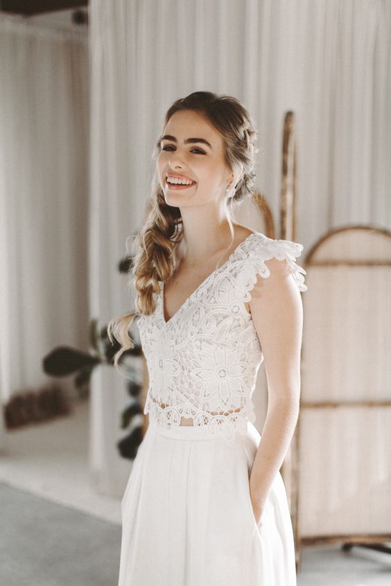 a gorgeous bridal look with a lace fitting crop top with cap sleeves and a V-neckline, high waisted plated palazzo pants with pockets