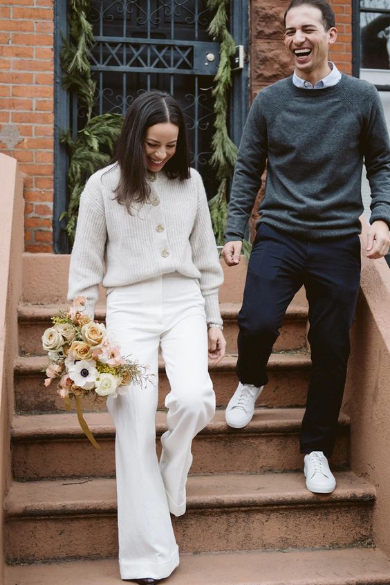 white flare pants and a neutral ribbed cardigan for a casual winter wedding ceremony at a city hall