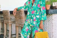 25 a super bright floral print pantsuit paired with catchy earrings and yellow mules and a bag for a summer garden wedding