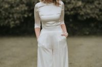 26 a modern elegant bridal look with a silk crop top with a high neckline and short sleeves and palazzo pants plus strands of pearls