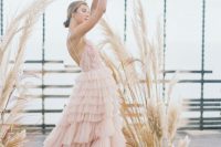 27 a fabulous pink A-line wedding dress with an open back, floral applique on the bodice and a ruffle skirt with a train