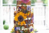 a cute summer wedding cake with pressed flowers
