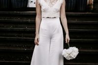 29 a refined modern bridal outfit with a plain crop top, high waisted wideleg and flare pants, statement earrings and a pearl headpiece