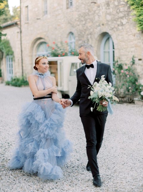 Picture Of a jaw dropping blue wedding dress with a halter neckline, a ruffle skirt and a black ribbon belt – all these are hot trends of 2022