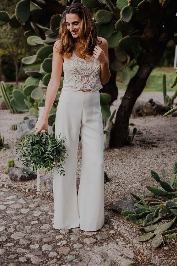 a romantic bridal look with a lace crop top with a scoop neckline and no sleeves and plain high waisted palazzo pants
