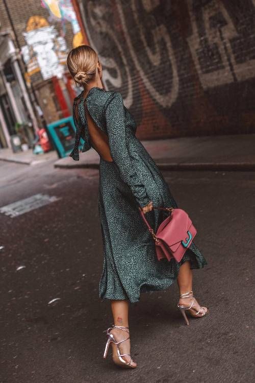 a refined dark green and white printed midi dress with an open back and long sleeves, silver heels and a pink bag
