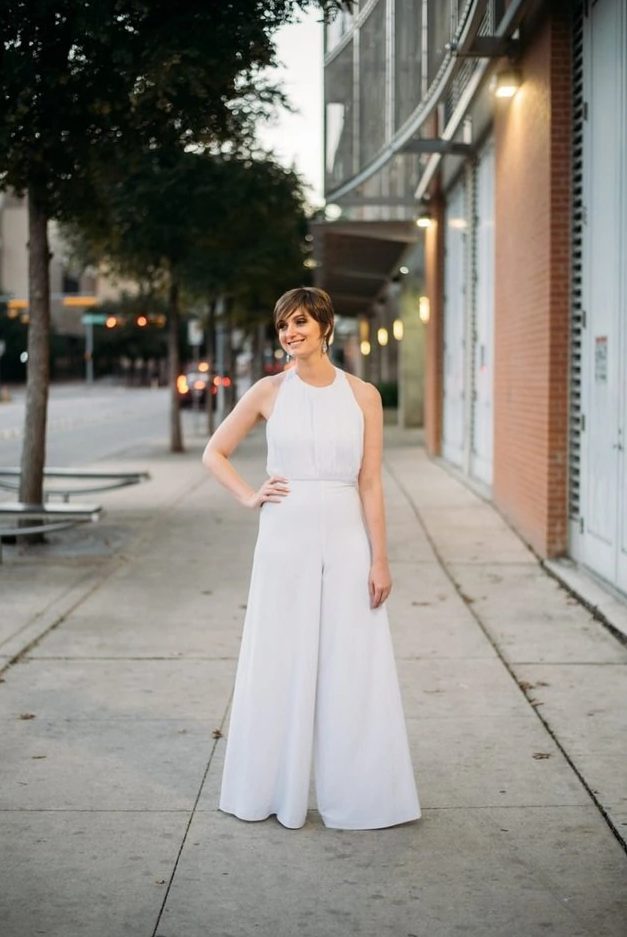 a stylish modern bridal look with a halter neckline top and very wideleg palazzo pants plus statement earrings
