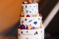 33 a semi naked wedding cake with pressed bright blooms and some dried flowers and leaf-shaped cookies is amazing for a fall wedding