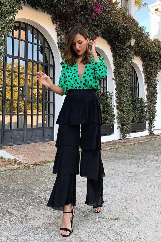 a super playful look with a green and black polka dot shirt and tiered ruffle pants plus black heels is a fun idea