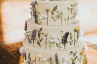 37 a tan wedding cake with pressed flowers and leaves looks very relaxed and boho-like is a lovely idea for spring
