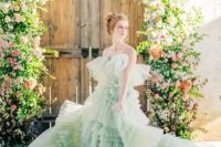 40 a unique pastel green tiered ruffle A-line wedding dress with a train and on spaghetti straps for more comfort is a unique idea