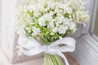 02 a beautiful and romantic white wedding bouquet of lily of the valley and large blooms with a ribbon bow is amazing