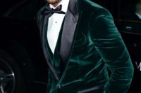 04 a chic black tie guest look with black trousers, a black bow tie, a white shirt with black buttons, an emerald velvet blazer and a matching waistcoat