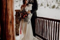 05 a fab chalet bridal look with a strapless wedding dress with a train and a white faux fur cover up plus a bold bouquet