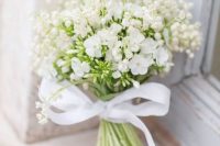06 a cute white wedding bouquet of lily of the valley and some other blooms plus a bow for a casual bride