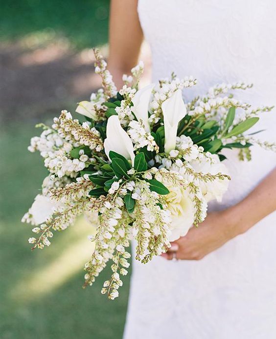 a lily of the vally wedding bouquet with greenery and calla lilies is a beautiful and creative idea of a spring wedding bouquet