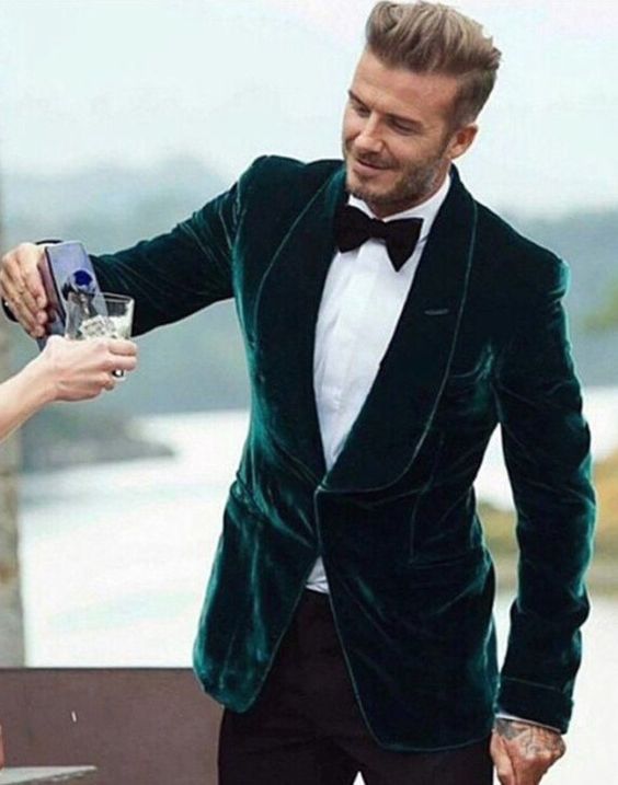 black trousers, a white shirt, an emerald velvet blazer and a black bow tie for a chic black tie wedding look