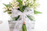 10 a pretty lily of the valley bouquet finished of beautifully with hessian and a lace bow for a vintage spring bride