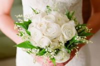 11 a refined spring wedding bouquet of lily of the valley, white ranunculus and greenery is a very chic solution