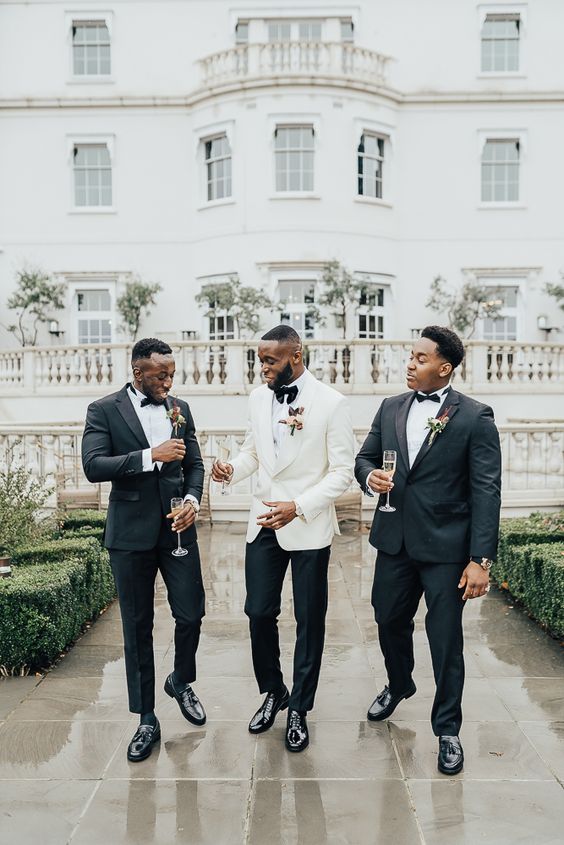 classic black tuxedos with shiny lapels, black socks and elegant shoes are all guys need to look super stylish at a black tie wedding