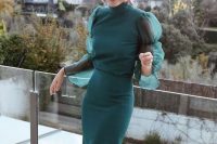 16 a beautiful and refined hunter green fitting midi dress with puff sleeves, a turtle neckline, statement burgundy earrings