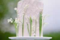 a blush textural wedding cake with white lily of the valley is a very chic and textural idea for a spring wedding
