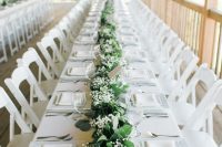 29 a gorgeous wedding tablescape done in white, with a greenery and lily of the valley table runner that refreshes the table