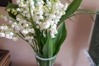 31 a vintage glass with foliage and lily of the vally is a lovely idea for a spring wedding and you can DIY such a centerpiece easily