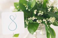 33 a wedding centerpiece of foliage and lily of the valley is a very chic and beautiful idea for spring weddings