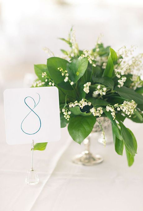 a wedding centerpiece of foliage and lily of the valley is a very chic and beautiful idea for spring weddings