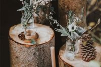 36 lovely winter lodge wedding decor of tree stumps, pinecones, greenery and cotton branches and boxes with moss and blooms